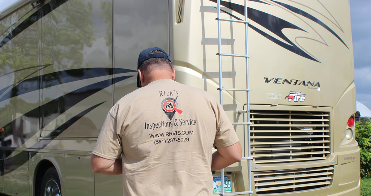 Rick Root, one of our RV Inspectors, inspecting the exterior of a fifth wheel motorhome